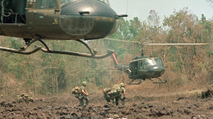 A helicopter hovers over the field, ready to load personnel and equipment during Operation Masher in the Vietnam War, May 7, 1966. (AP Photo)